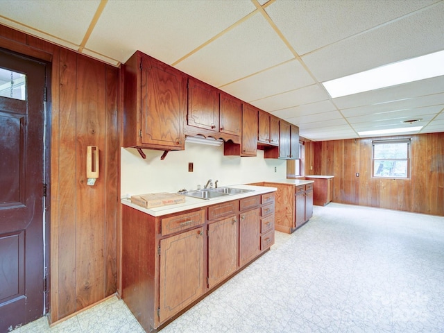 167 Cedar Ln, Troutman, NC 28166 - kitchen featuring a sink, wood walls, light flooring, a paneled ceiling, and light countertops