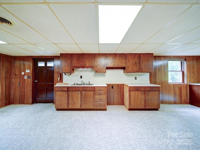 167 Cedar Ln, Troutman, NC 28166 - kitchen with wooden walls, a drop ceiling, a sink, brown cabinets, and light countertops