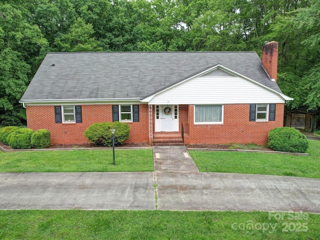 167 Cedar Ln, Troutman, NC 28166 - view of front facade featuring brick siding, a front lawn, and a chimney