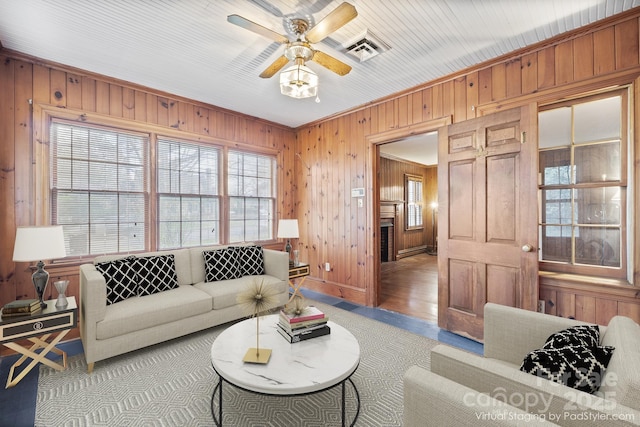 431 Sullivan Rd, Statesville, NC 28677 - living area featuring wooden walls, a ceiling fan, light wood-style flooring, and a baseboard radiator