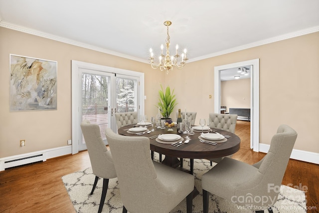 431 Sullivan Rd, Statesville, NC 28677 - dining area with a chandelier, crown molding, a baseboard radiator, and light wood-type flooring