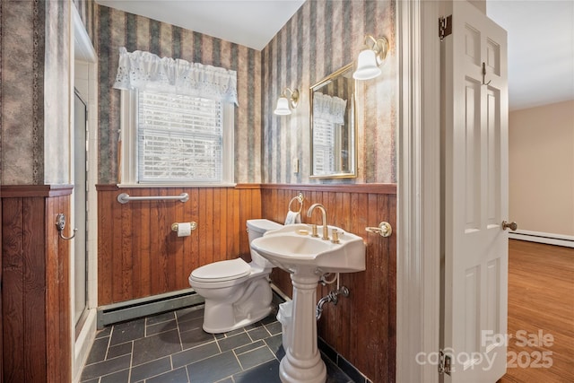 431 Sullivan Rd, Statesville, NC 28677 - bathroom featuring baseboard heating, wainscoting, wallpapered walls, toilet, and a stall shower