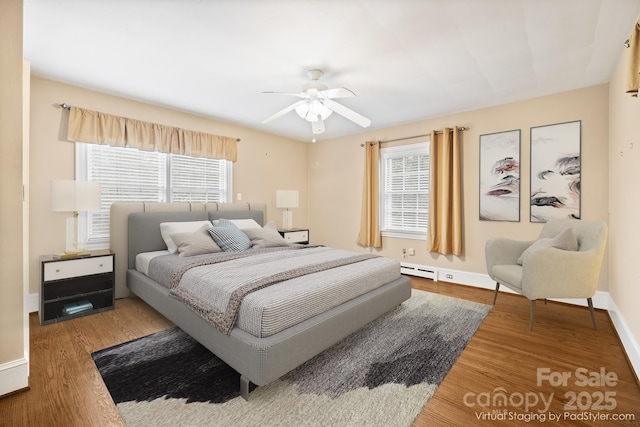 431 Sullivan Rd, Statesville, NC 28677 - bedroom with a baseboard radiator, wood finished floors, baseboards, and a ceiling fan