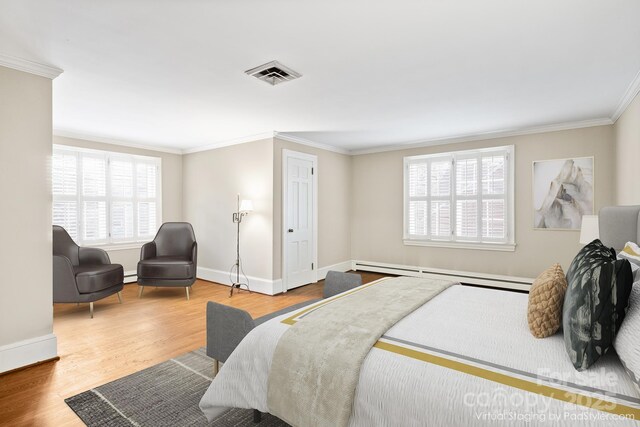 431 Sullivan Rd, Statesville, NC 28677 - bedroom featuring a baseboard heating unit, crown molding, baseboards, and wood finished floors