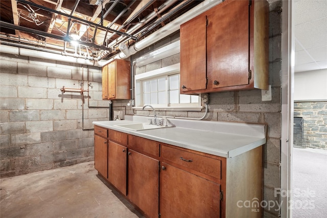 431 Sullivan Rd, Statesville, NC 28677 - kitchen with a sink, unfinished concrete flooring, light countertops, and brown cabinetry