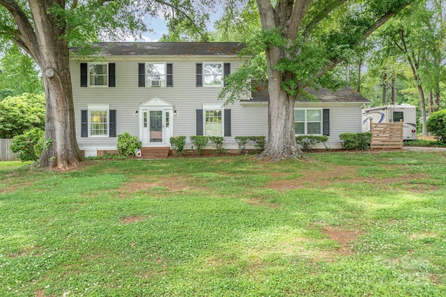 colonial inspired home featuring a front lawn