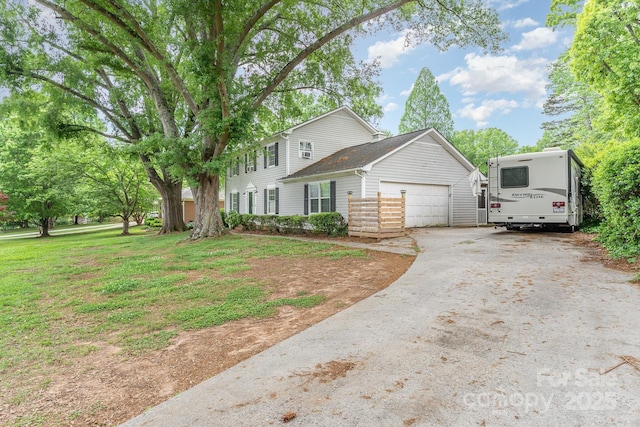 view of front of house featuring a front yard, driveway, and an attached garage