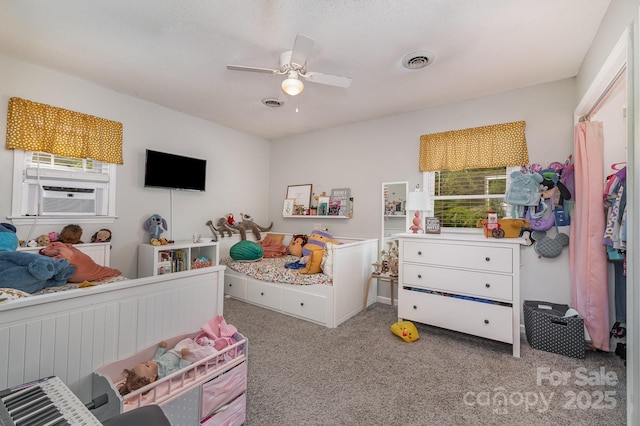 carpeted bedroom with visible vents, cooling unit, multiple windows, and ceiling fan