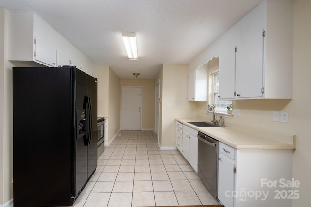 kitchen with stainless steel appliances, a sink, white cabinets, and a textured ceiling