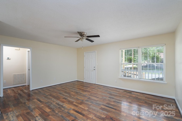 empty room featuring ceiling fan, wood finished floors, and baseboards