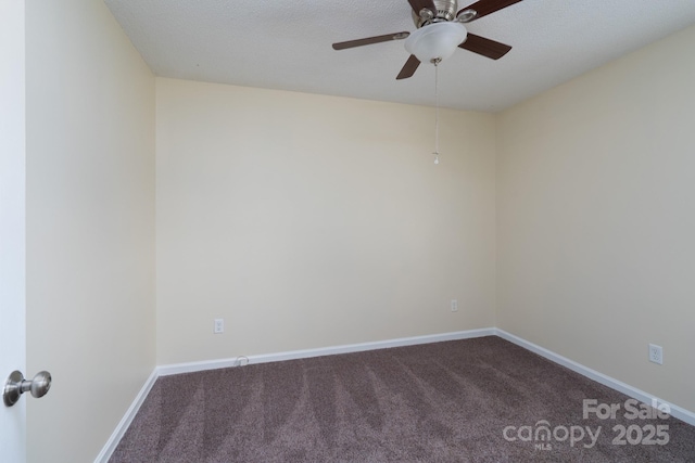 carpeted spare room with a ceiling fan and baseboards