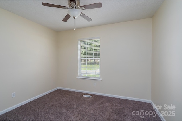 spare room featuring carpet floors, baseboards, and a ceiling fan