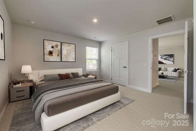 bedroom featuring baseboards, visible vents, and carpet