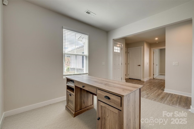 unfurnished office with baseboards, light wood finished floors, visible vents, and recessed lighting