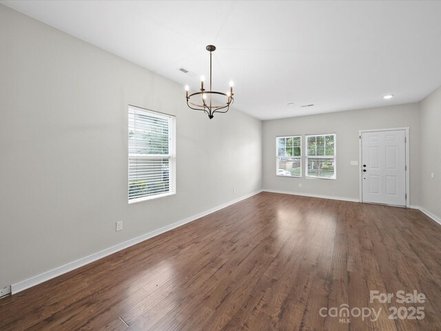 113 Devynn Ridge Ct, Mount Holly, NC 28120 - unfurnished room featuring baseboards, recessed lighting, dark wood-style floors, visible vents, and a notable chandelier