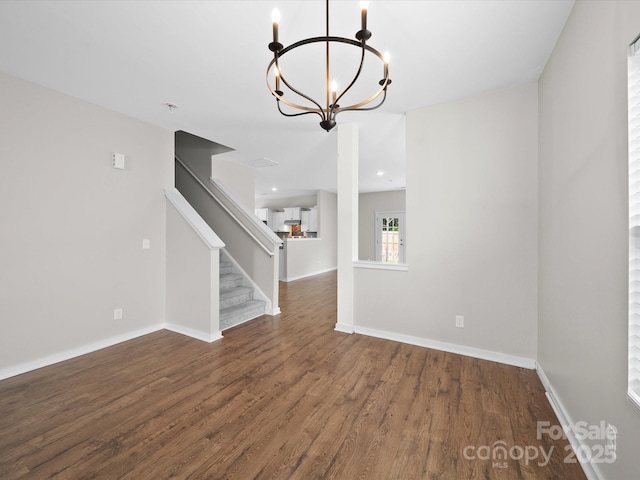 113 Devynn Ridge Ct, Mount Holly, NC 28120 - interior space featuring baseboards, stairway, wood finished floors, and a notable chandelier
