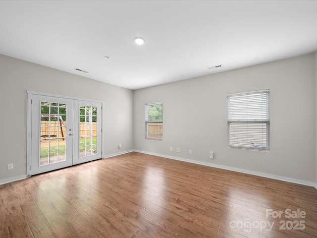 113 Devynn Ridge Ct, Mount Holly, NC 28120 - unfurnished room with baseboards, visible vents, wood finished floors, and french doors