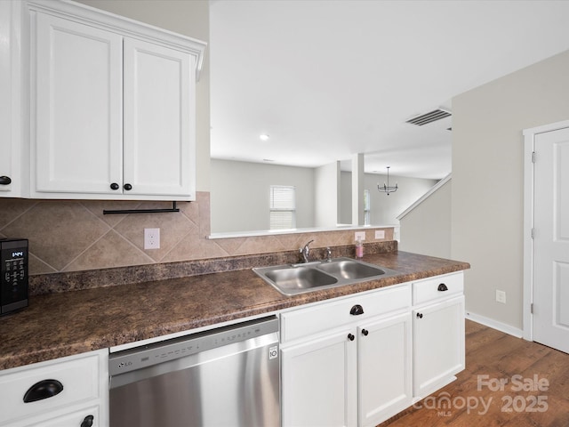 113 Devynn Ridge Ct, Mount Holly, NC 28120 - kitchen with decorative backsplash, stainless steel dishwasher, a sink, dark countertops, and visible vents