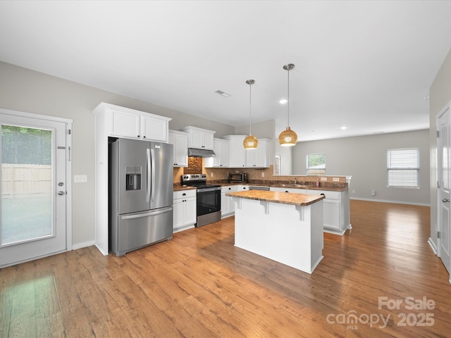 113 Devynn Ridge Ct, Mount Holly, NC 28120 - kitchen with white cabinets, a kitchen breakfast bar, a peninsula, and appliances with stainless steel finishes