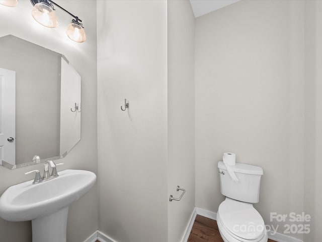 113 Devynn Ridge Ct, Mount Holly, NC 28120 - bathroom with toilet, a sink, wood finished floors, and baseboards