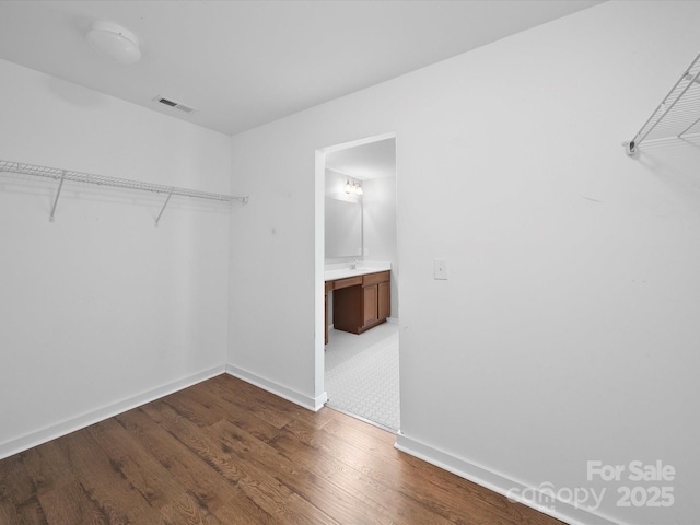 113 Devynn Ridge Ct, Mount Holly, NC 28120 - walk in closet with visible vents and wood finished floors