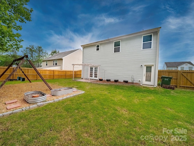 113 Devynn Ridge Ct, Mount Holly, NC 28120 - back of house featuring a fire pit, french doors, a fenced backyard, and a lawn