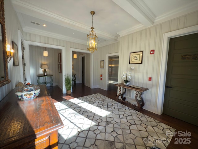 interior space with beamed ceiling, visible vents, elevator, a notable chandelier, and wood finished floors