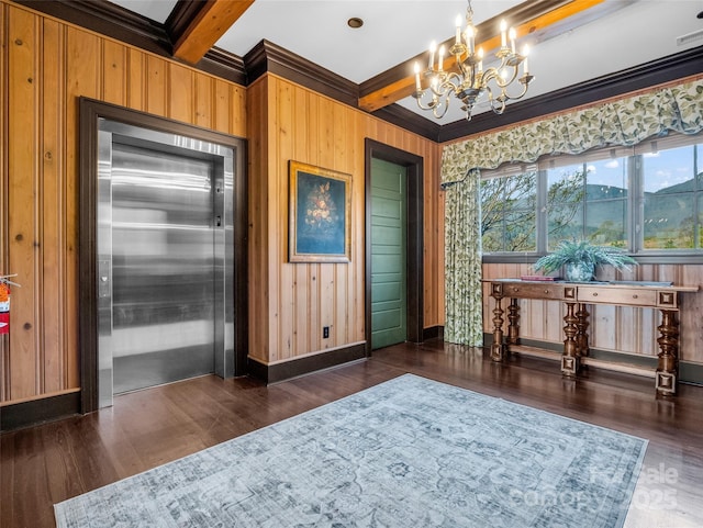 interior space featuring an inviting chandelier, baseboards, beamed ceiling, elevator, and wood finished floors