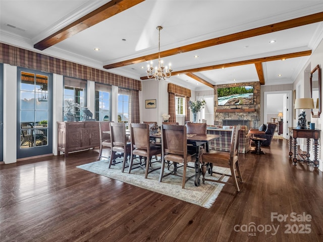 dining room with a notable chandelier, crown molding, wood finished floors, and beam ceiling