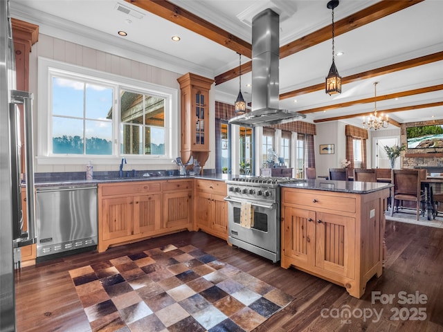 kitchen featuring island range hood, stainless steel appliances, beamed ceiling, a peninsula, and a notable chandelier
