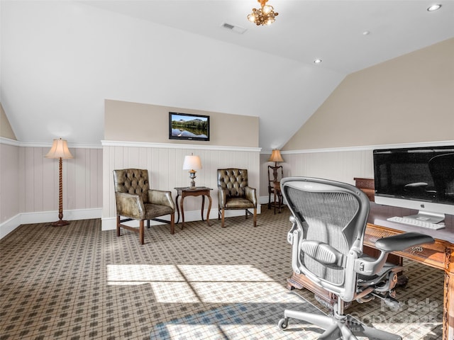 carpeted home office featuring baseboards, lofted ceiling, and visible vents