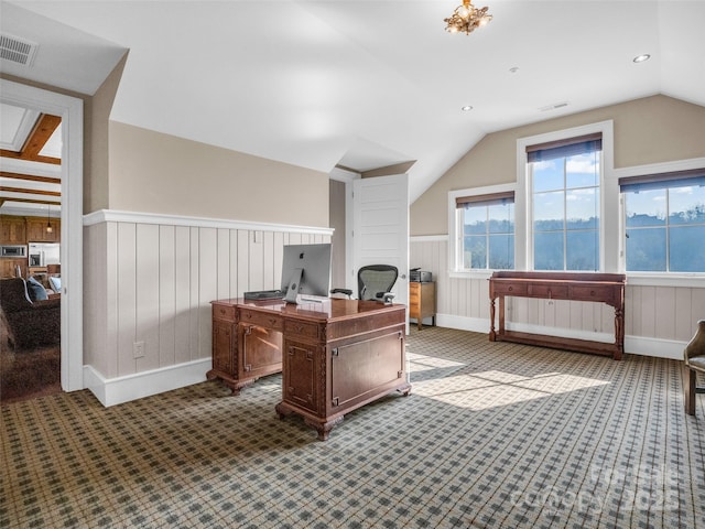 home office with visible vents, dark carpet, wainscoting, and vaulted ceiling