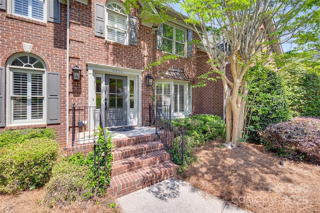 property entrance featuring brick siding