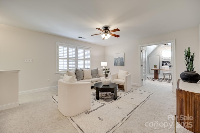 living room with visible vents, a ceiling fan, and carpet floors