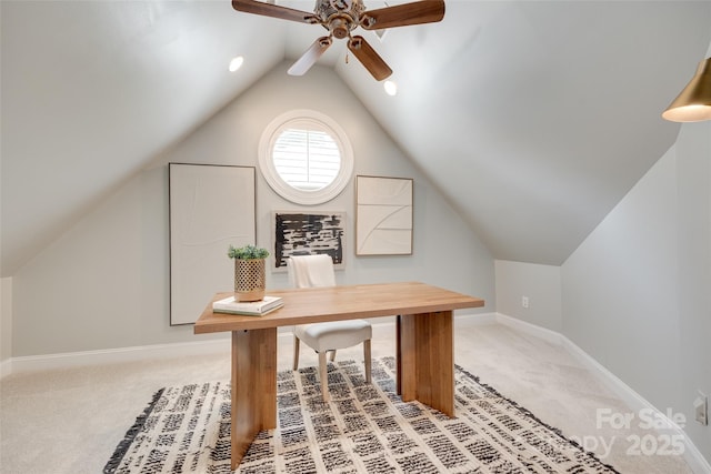 office area with ceiling fan, light colored carpet, baseboards, and lofted ceiling