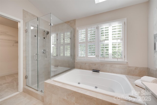 full bath with a spacious closet, a wealth of natural light, a bath, and a stall shower