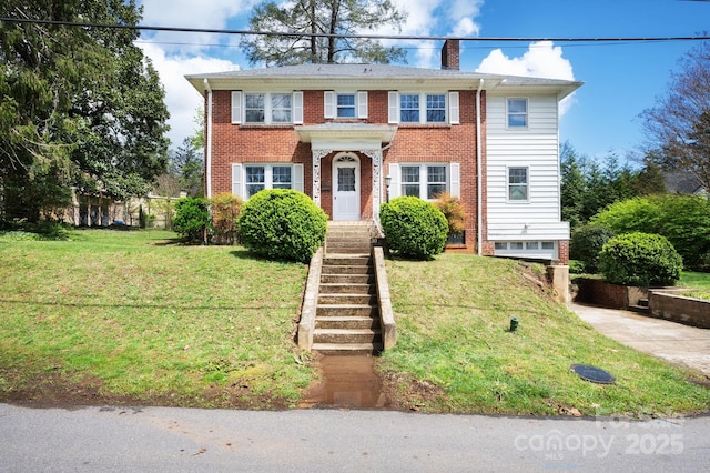 10 Westchester Dr, Asheville, NC 28803 - colonial house featuring a chimney, a front lawn, and brick siding