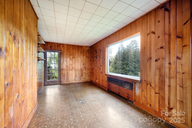 10 Westchester Dr, Asheville, NC 28803 - unfurnished living room featuring wooden walls, tile patterned floors, and baseboards