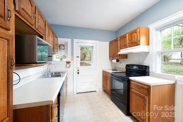 10 Westchester Dr, Asheville, NC 28803 - kitchen with stainless steel microwave, light countertops, black electric range, under cabinet range hood, and a sink