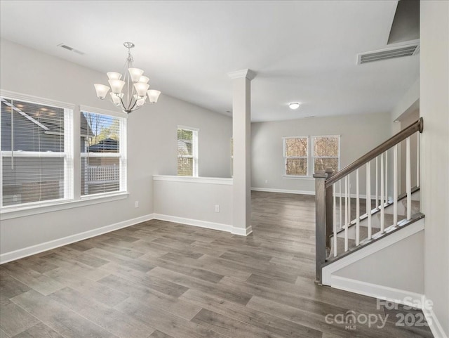 interior space featuring wood finished floors, plenty of natural light, and visible vents