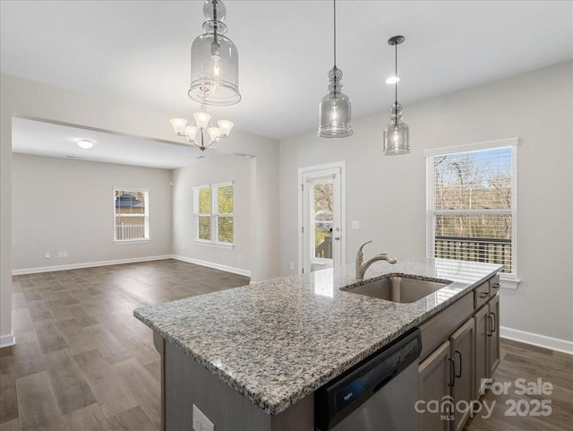 kitchen featuring a sink, pendant lighting, dishwasher, baseboards, and dark wood-style flooring