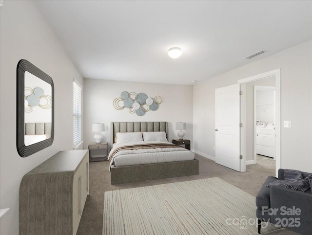 bedroom featuring washer and clothes dryer, carpet, baseboards, and visible vents