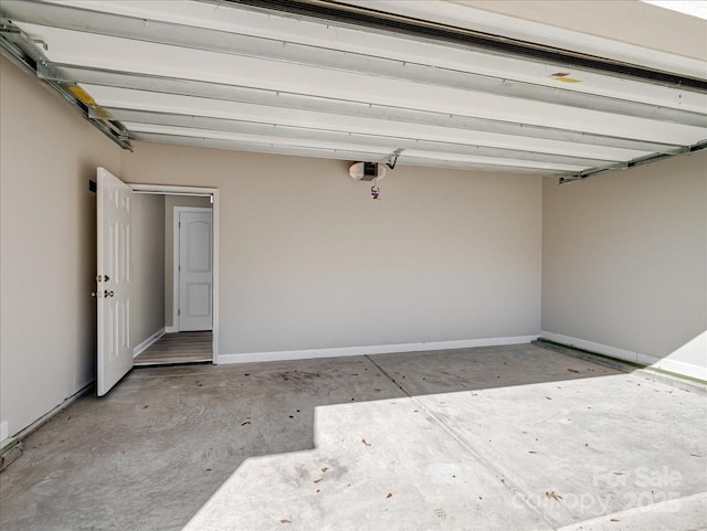garage featuring baseboards and a garage door opener