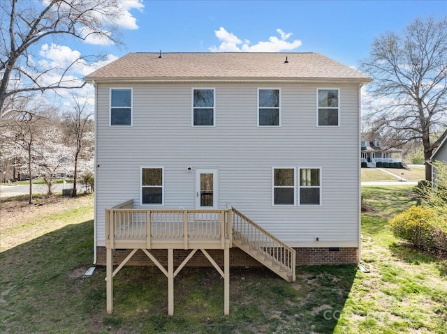 rear view of house featuring a yard, stairway, and a deck