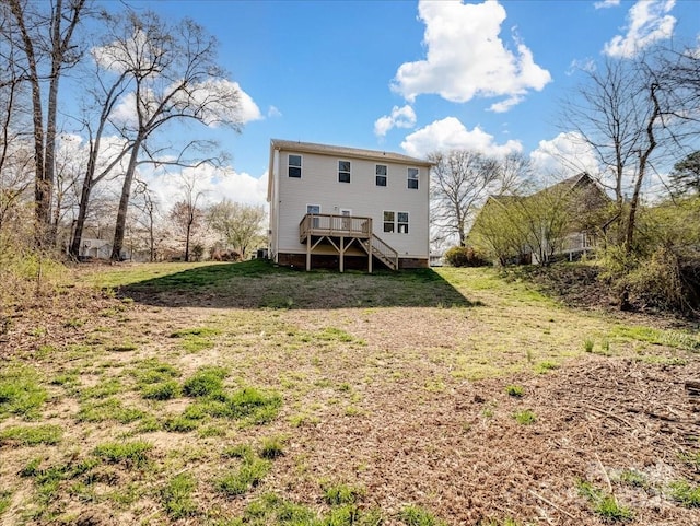 back of house featuring a yard, stairway, and a deck
