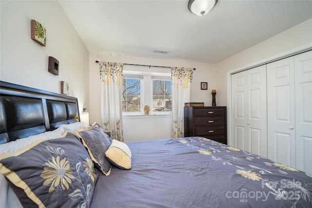 bedroom with a closet and visible vents