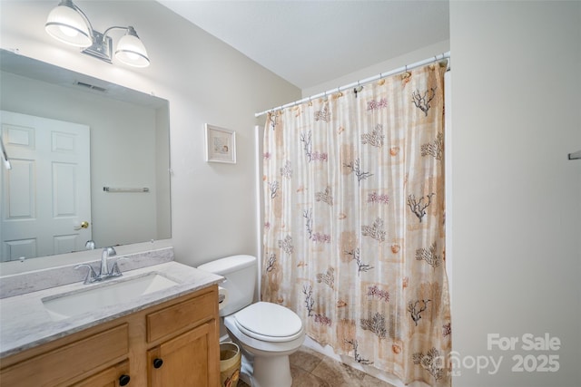 bathroom featuring toilet, vanity, a shower with curtain, tile patterned flooring, and visible vents