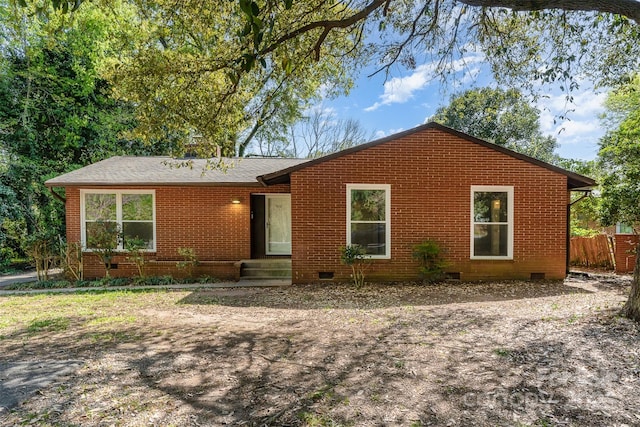 ranch-style home featuring brick siding, crawl space, and fence