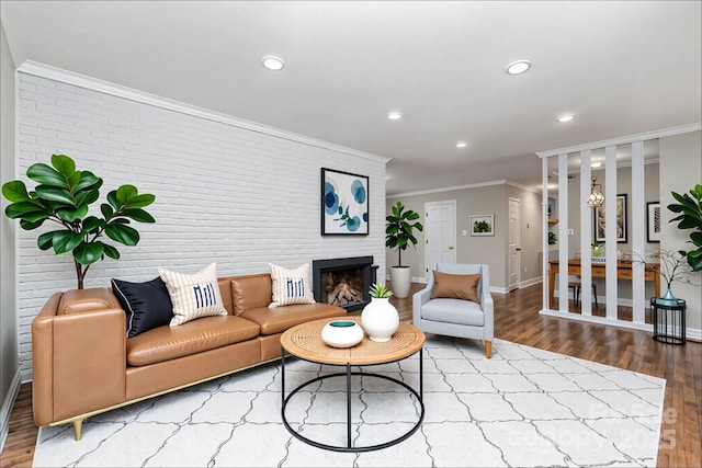 900 E Woodlawn Rd, Charlotte, NC 28209 - living area with wood finished floors, ornamental molding, recessed lighting, brick wall, and a fireplace