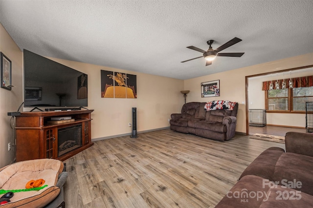 266 Asheland Dr, Ellenboro, NC 28040 - living room with baseboards, a textured ceiling, a ceiling fan, and wood finished floors